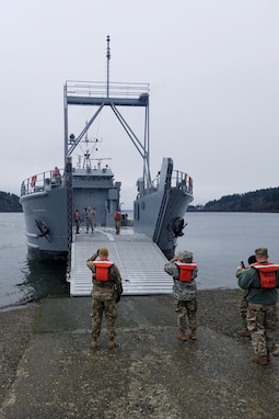Soldiers prepare a logistics support vessel to receive cargo before the start of a mission in Baltimore, Maryland that is traveling to Washington state.