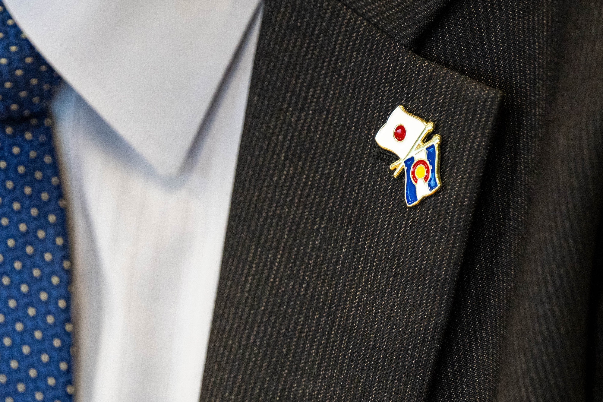 u.s. flag and japanese flag pin on suit