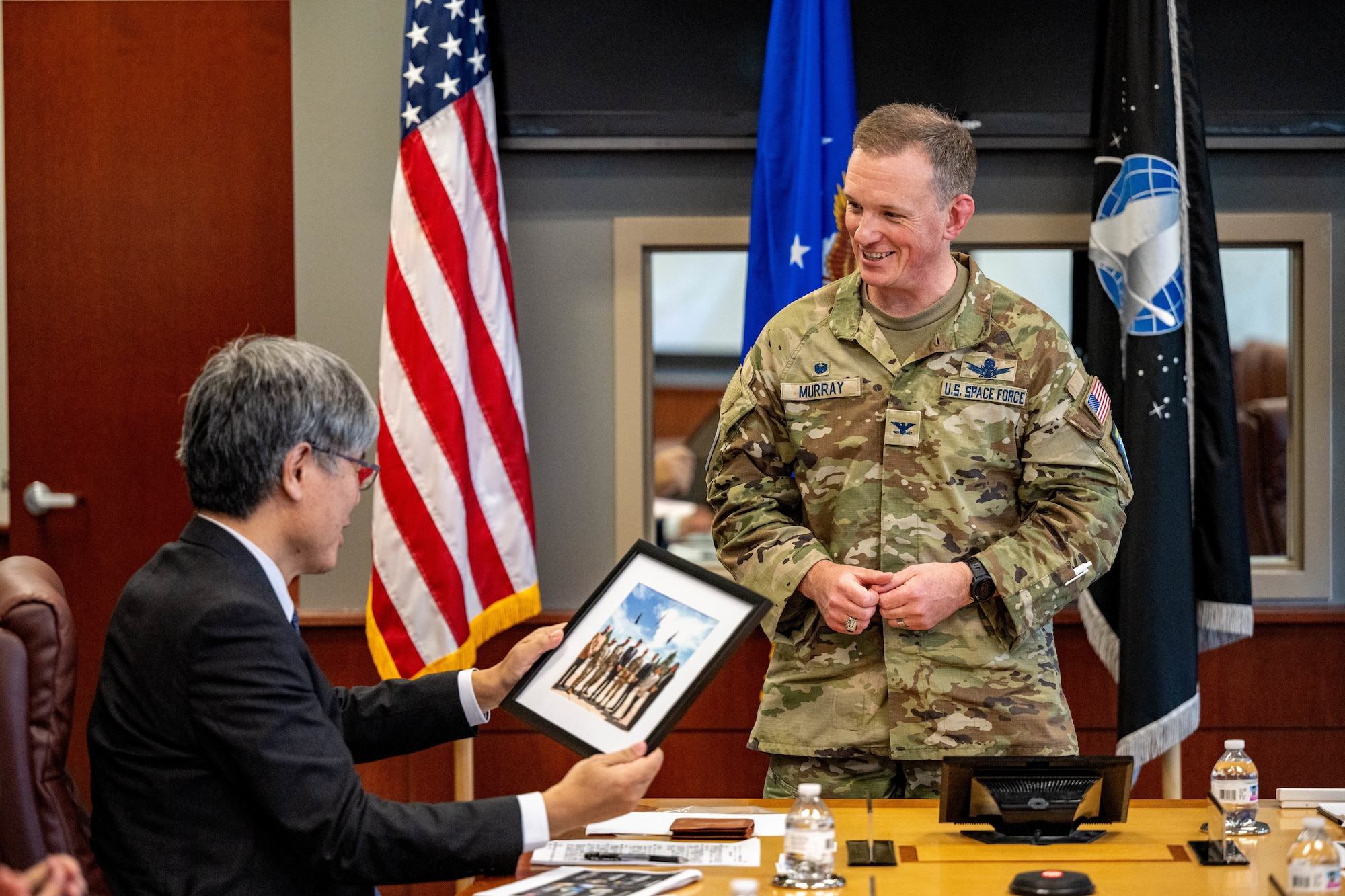 Man presenting man photograph