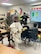 A student tries on a Biosafety Level 4 Positive Pressure Suit with assistance from Capt. Jesus Silvas, a microbiologist with the U.S. Army Reserve Medical Command assigned to the 59th Medical Wing’s Office of Research and Technology Applications, Aug. 7, 2025, at Mendez Elementary School in San Marcos, Texas, as Dr. Israel Guerrero, a virologist with Texas Biomedical Research Institute, describes laboratory safety levels.