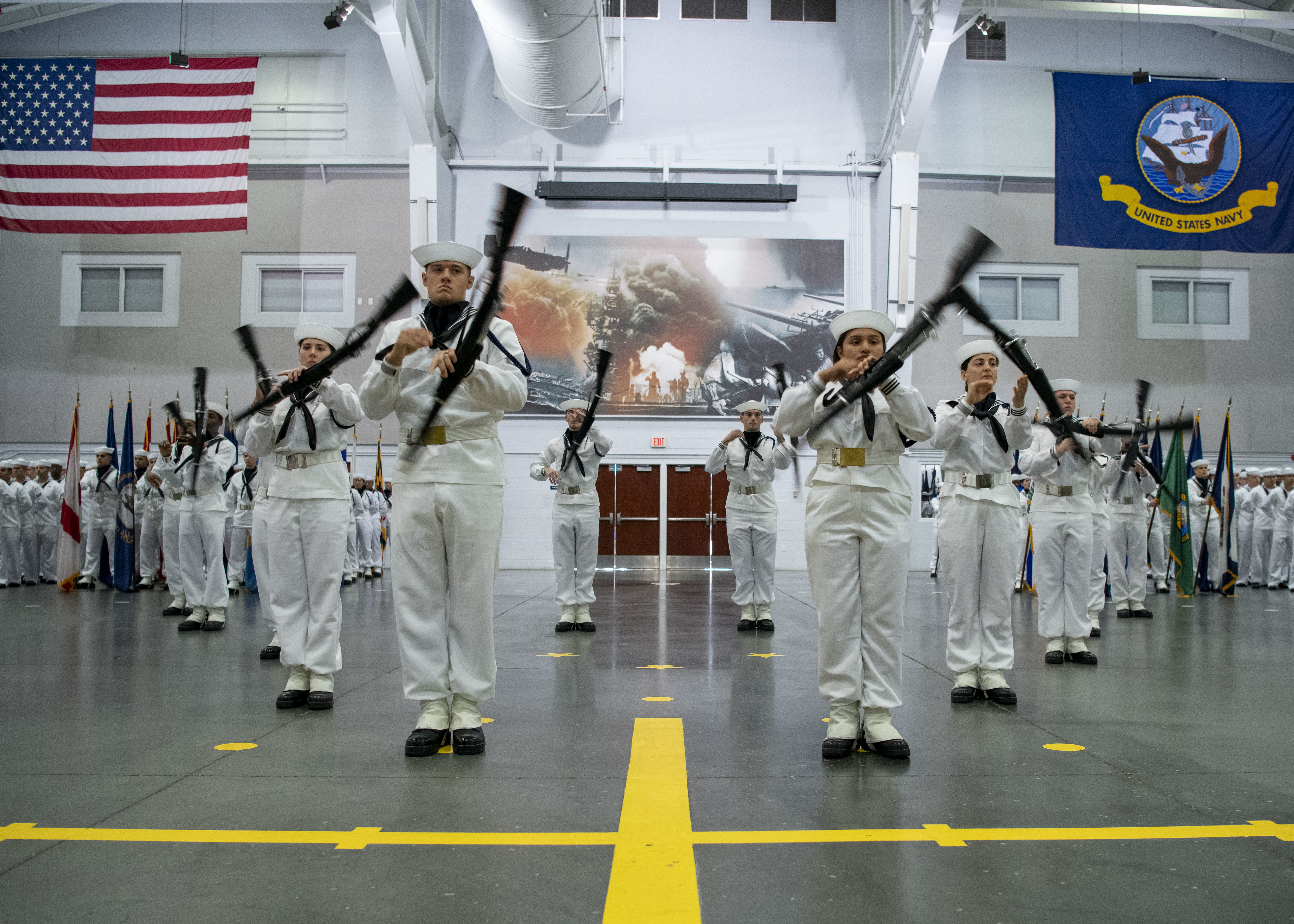 The recruit drill team performs during pass-in-review onboard U.S. Navy Recruit Training Command in Great Lakes, July 31, 2025. Training is approximately nine weeks and all enlistees in the U.S. Navy begin their career at the command. More than 40,000 recruits train annually at the Navy's only boot camp.