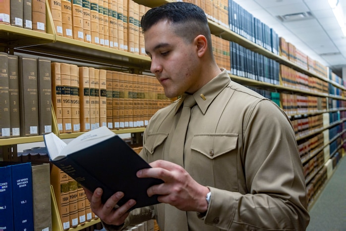 U.S. Marine Corps 2nd Lt. Juan C. Ibarra, a student judge advocate, and a native of Oklahoma City, reads a book in the Donald E. Pray Library at the University of Oklahoma College of Law, Norman, Okla., Jan. 28, 2025. Ibarra is currently in his first year of law school and is preparing to become a Marine Corps judge advocate where he will be responsible for upholding the law and core values of the Marine Corps. (U.S. Marine Corps photo by Sgt. Lennon Dregoiw)