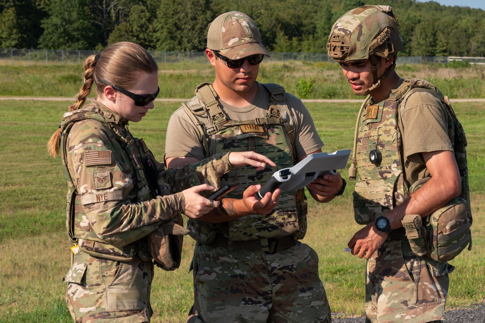U.S. Air Force Airmen assigned to the 21st Combat Air Base Squadron analyze data from a small Unmanned Aircraft System controller during exercise Bamboo Eagle 25-3 at Camp Robinson, Arkansas, August 4, 2025. As a key component of the 21st Air Task Force, CABS Airmen are learning to employ sUAS as a low-cost, high-value asset for site security, damage reconnaissance, and force protection. (U.S. Air Force photo by Airman 1st Class Adrien Tran)