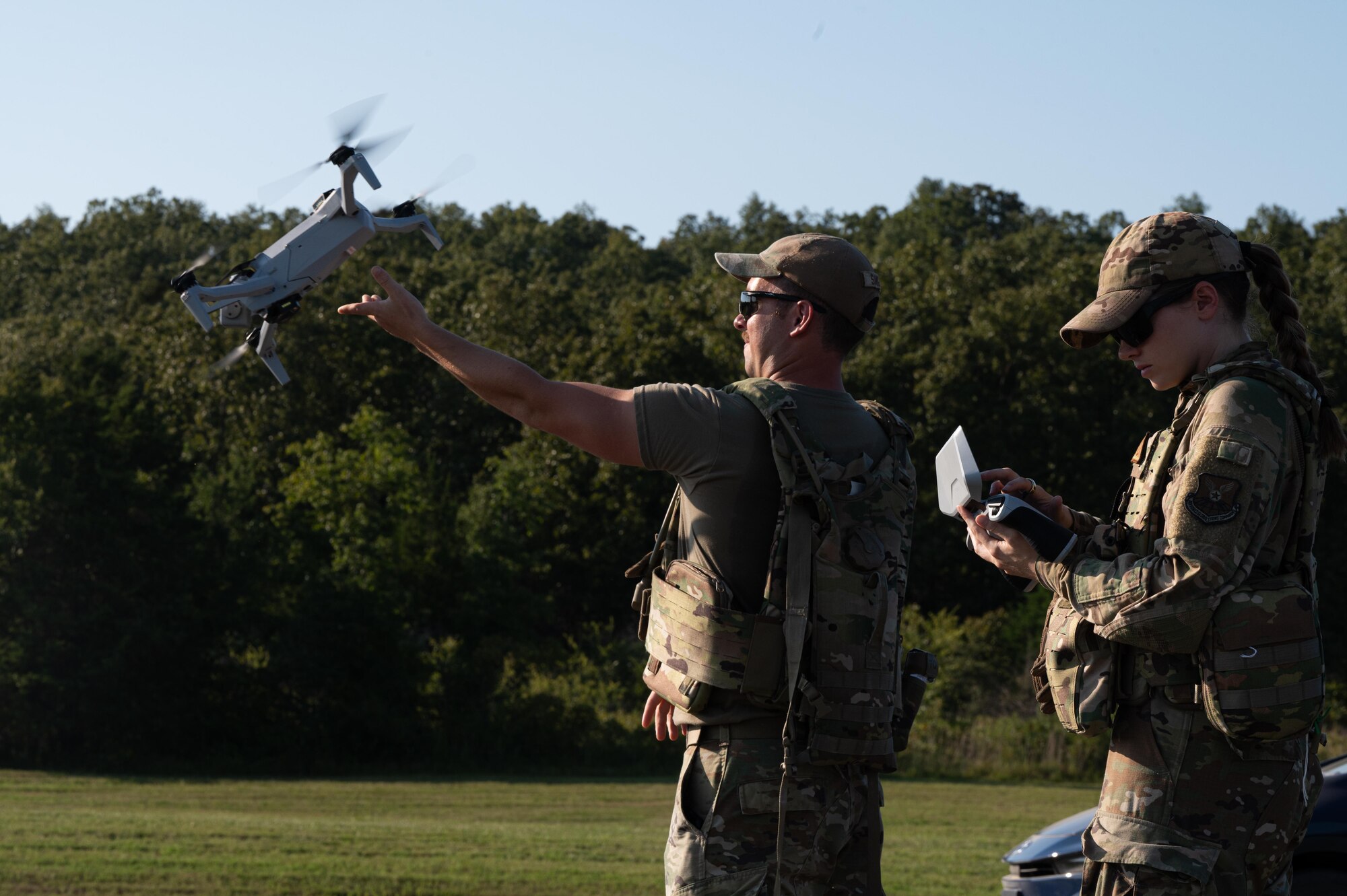 U.S. Air Force Airman 1st Class Graham Sargeant, 21st Combat Air Base Squadron structural journeyman, launches a small Unmanned Aircraft System during exercise Bamboo Eagle 25-3 at Camp Robinson, Arkansas, August 4, 2025. The sUAS allows Airmen to conduct faster site assessments while minimizing risk to personnel. (U.S. Air Force photo by Airman 1st Class Adrien Tran)