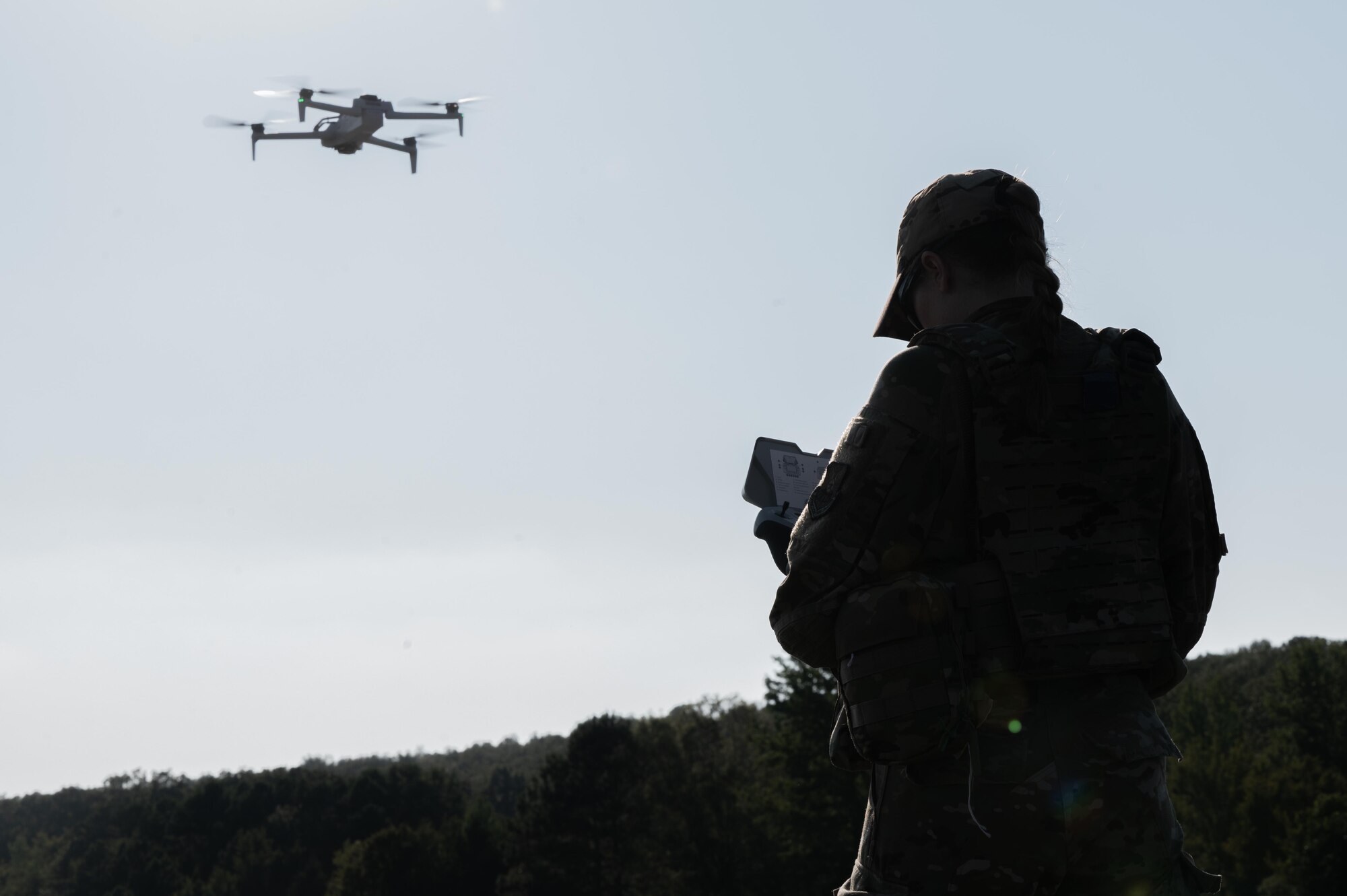 U.S. Staff Sgt. Rikki Nye, 21st Combat Air Base Squadron noncommissioned officer in charge of liquid fuels maintenance, configures coordinates for a small Unmanned Aircraft System during exercise Bamboo Eagle 25-3 at Camp Robinson, Arkansas, August 4, 2025. The integration of these systems aligns with Agile Combat Employment principles by improving speed, flexibility and survivability in contested environments. (U.S. Air Force photo by Airman 1st Class Adrien Tran)