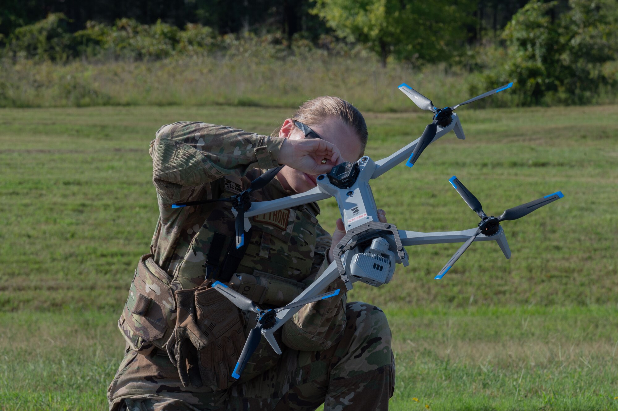 U.S. Staff Sgt. Rikki Nye, 21st Combat Air Base Squadron noncommissioned officer in charge of liquid fuels maintenance, prepares a small Unmanned Aircraft System for flight during exercise Bamboo Eagle 25-3 at Camp Robinson, Arkansas, August 4, 2025. The integration of these systems aligns with Agile Combat Employment principles by improving speed, flexibility and survivability in contested environments. (U.S. Air Force photo by Senior Airman Alondra Cristobal Hernandez)