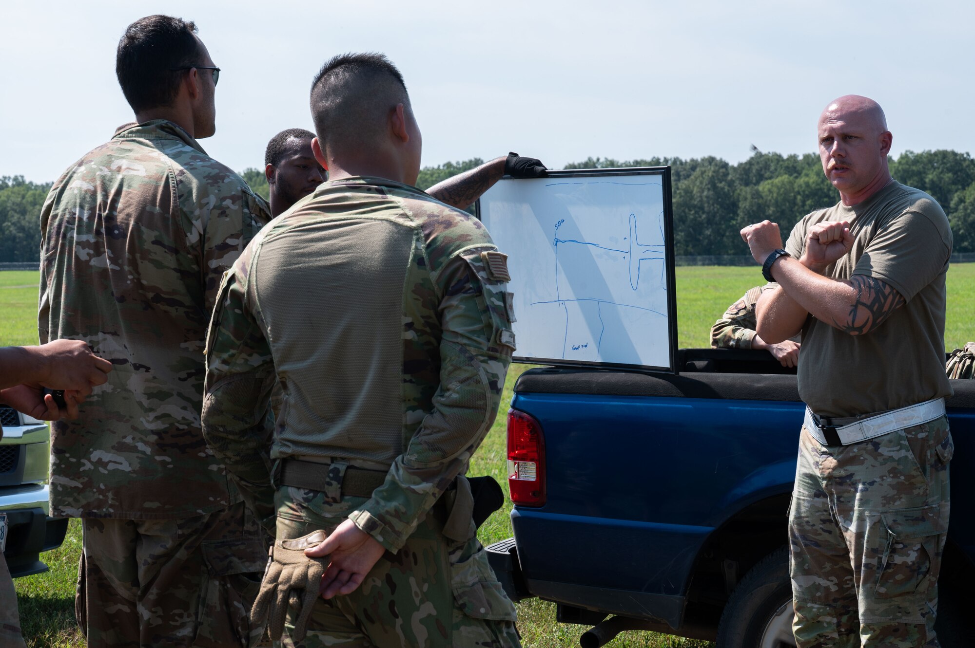 U.S. Air Force Master Sgt. Kevin Bolton, 21st Air Task Force air transportation superintendent, debriefs Airmen on landing zone procedures during exercise Bamboo Eagle 25-3 at Camp Robinson, Arkansas, August 4, 2025. BE 25-3 supported the 21st ATF’s commitment to execute rapid force flow in contested environments. (U.S. Air Force photo by Senior Airman Alondra Cristobal Hernandez)