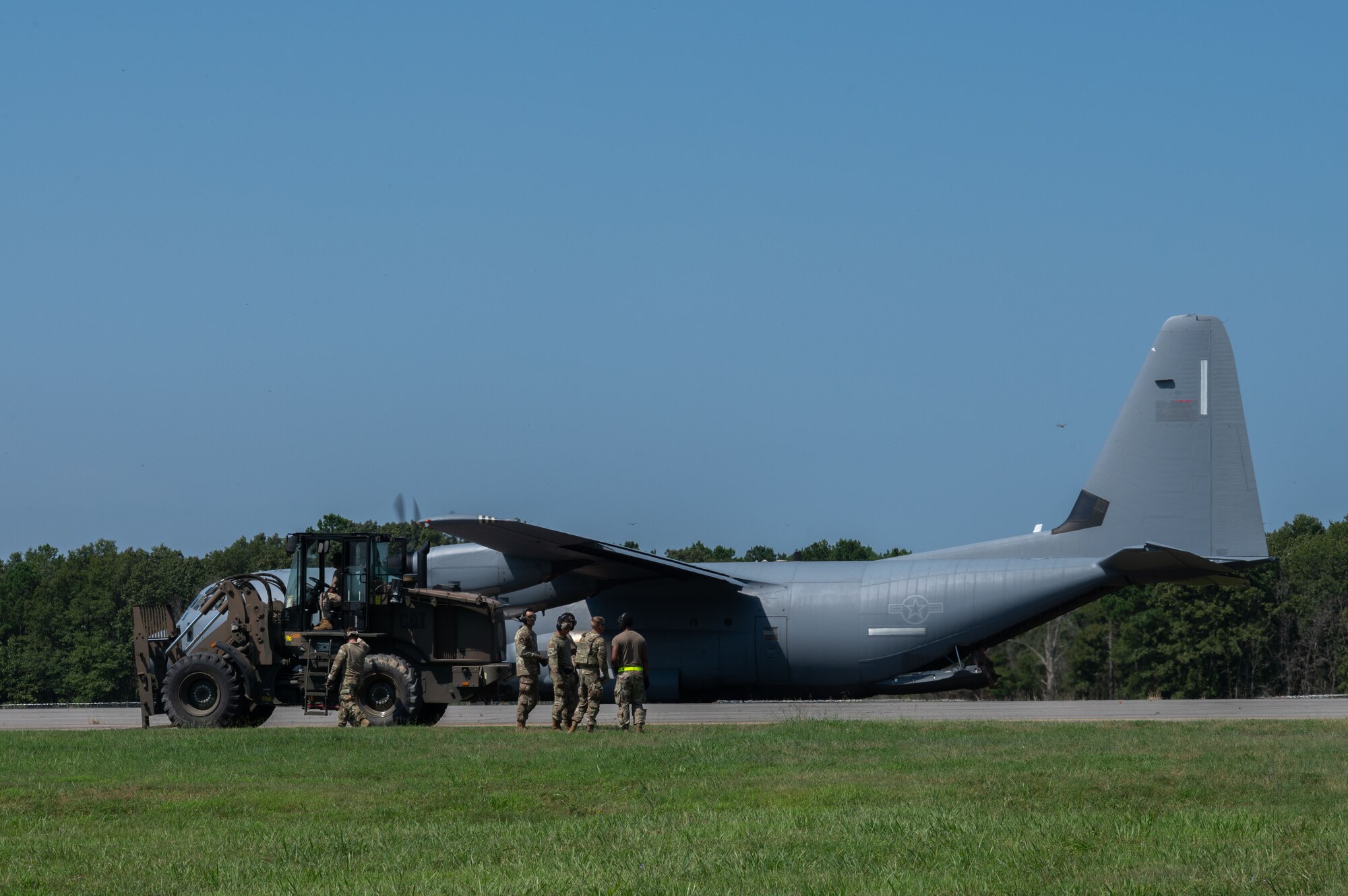 U.S. Air Force Airmen assigned to the 21st Combat Air Base Squadron prepare to off-load materials during exercise Bamboo Eagle 25-3 at Camp Robinson, Arkansas, August 4, 2025. During BE 25-3 21st CABS Airmen leveraged innovation and training to overcome operational challenges in support of Agile Combat Employment. (U.S. Air Force photo by Senior Airman Alondra Cristobal Hernandez)