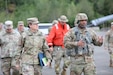 Lt. Col. Jackson of the 3rd Transportation Brigade (Expeditionary) walks with Brig. Gen. Rachel E. Humphrey, deputy commander of the 377th Theater Sustainment Command, and discusses their current Arctic Edge activities at Port McKenzie, Alaska, as well as other training exercises.
