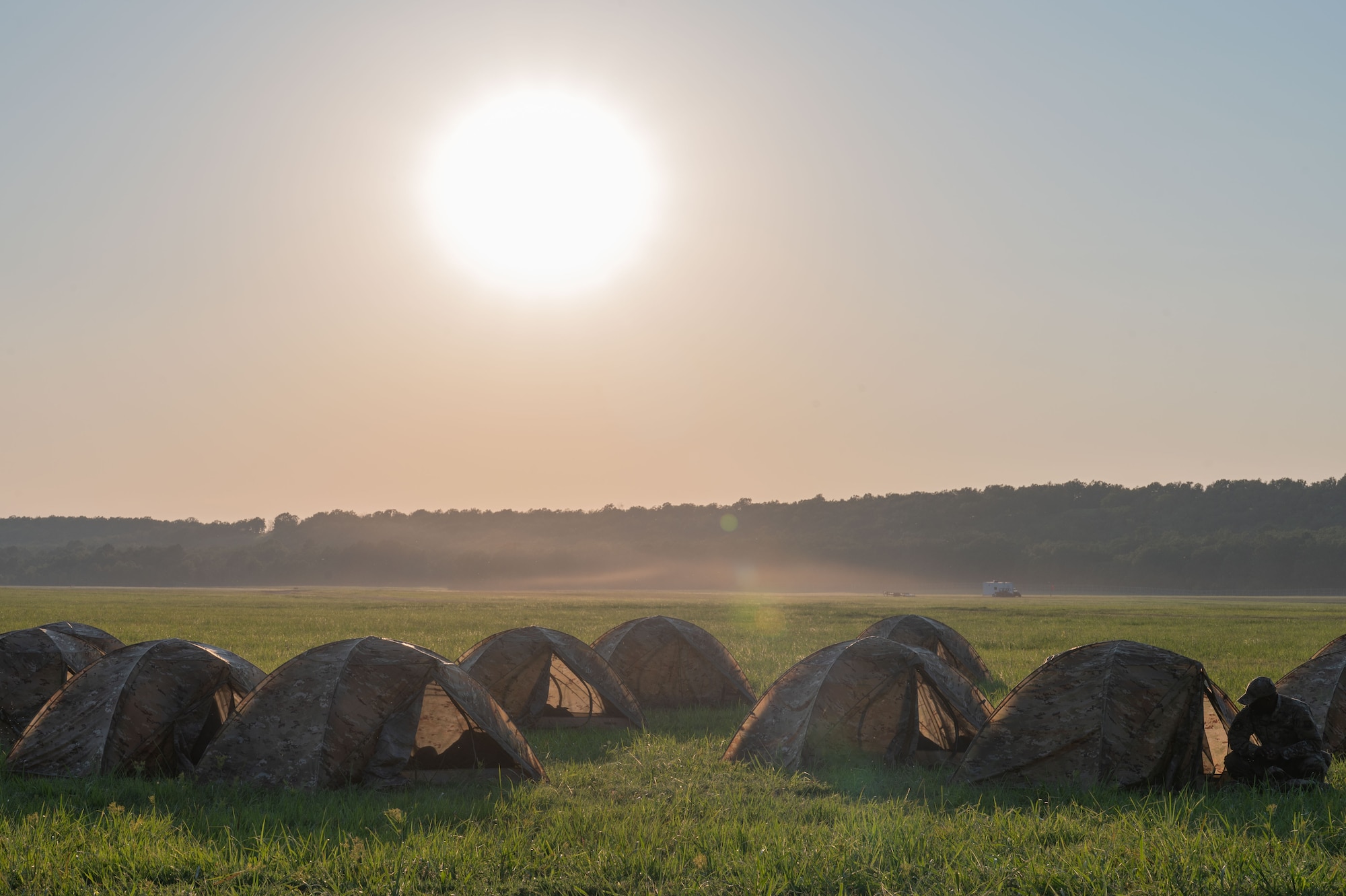 Airmen assigned to the 21st Combat Air Base Squadron set up tents at a contingency location during exercise Bamboo Eagle 25-3 at Camp Robinson, Arkansas, Aug. 4, 2025. Exercise BE 25-3 pushed participants to refine their skills, innovate solutions, and adapt to complex operational challenges in a combat-representative environment. (U.S. Air Force photo by Senior Airman Alondra Cristobal)