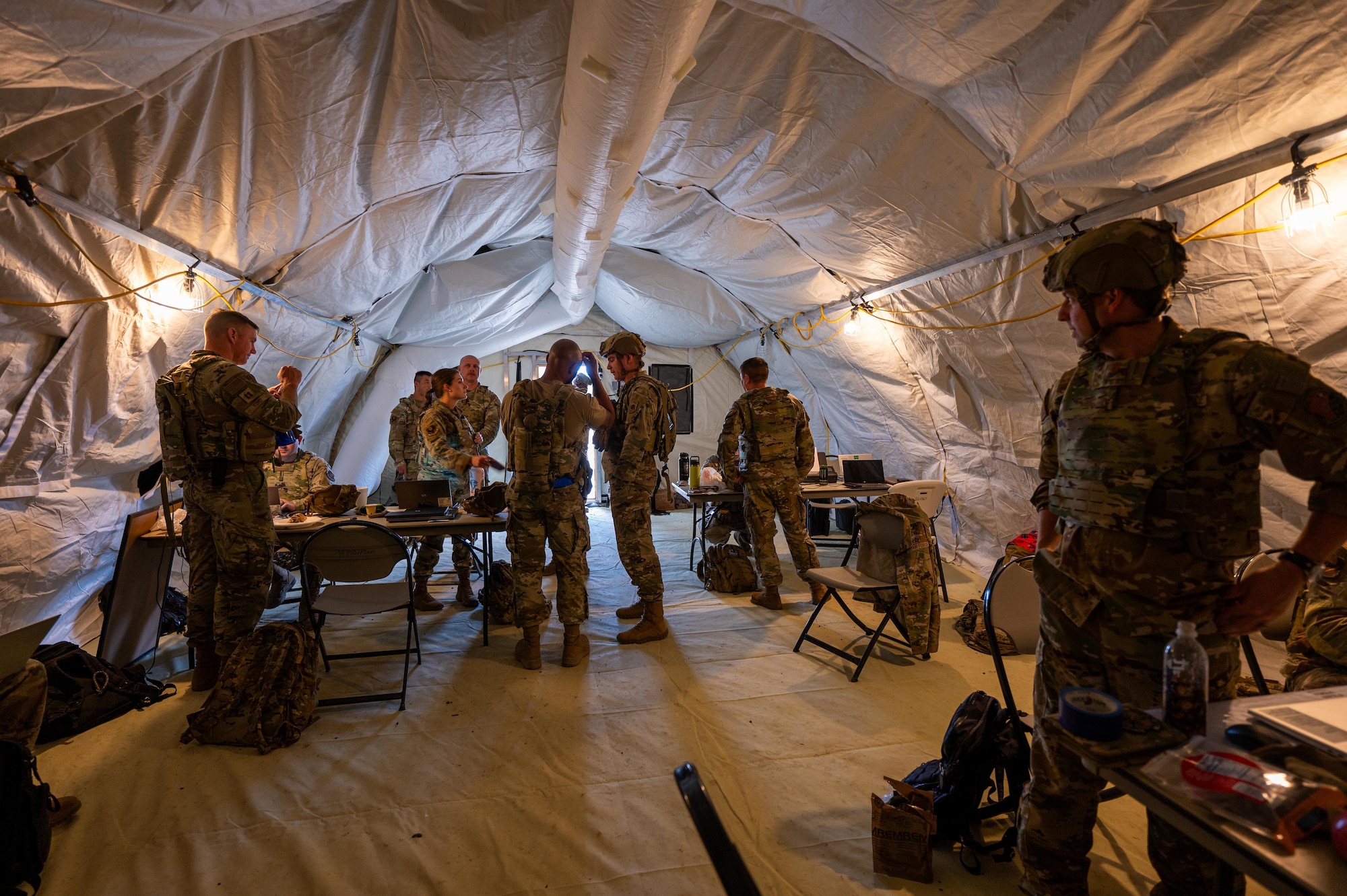 U.S. Airmen assigned to the 21st Air Task Force operate in a command center during exercise Bamboo Eagle 25-3 at Camp Robinson, Arkansas, Aug. 6, 2025. BE 25-3 strengthened the 21st ATF’s ability to conduct rapid deployment, sustainment and operations in contested environments. (U.S. Air Force photo by Airman 1st Class Adrien Tran)