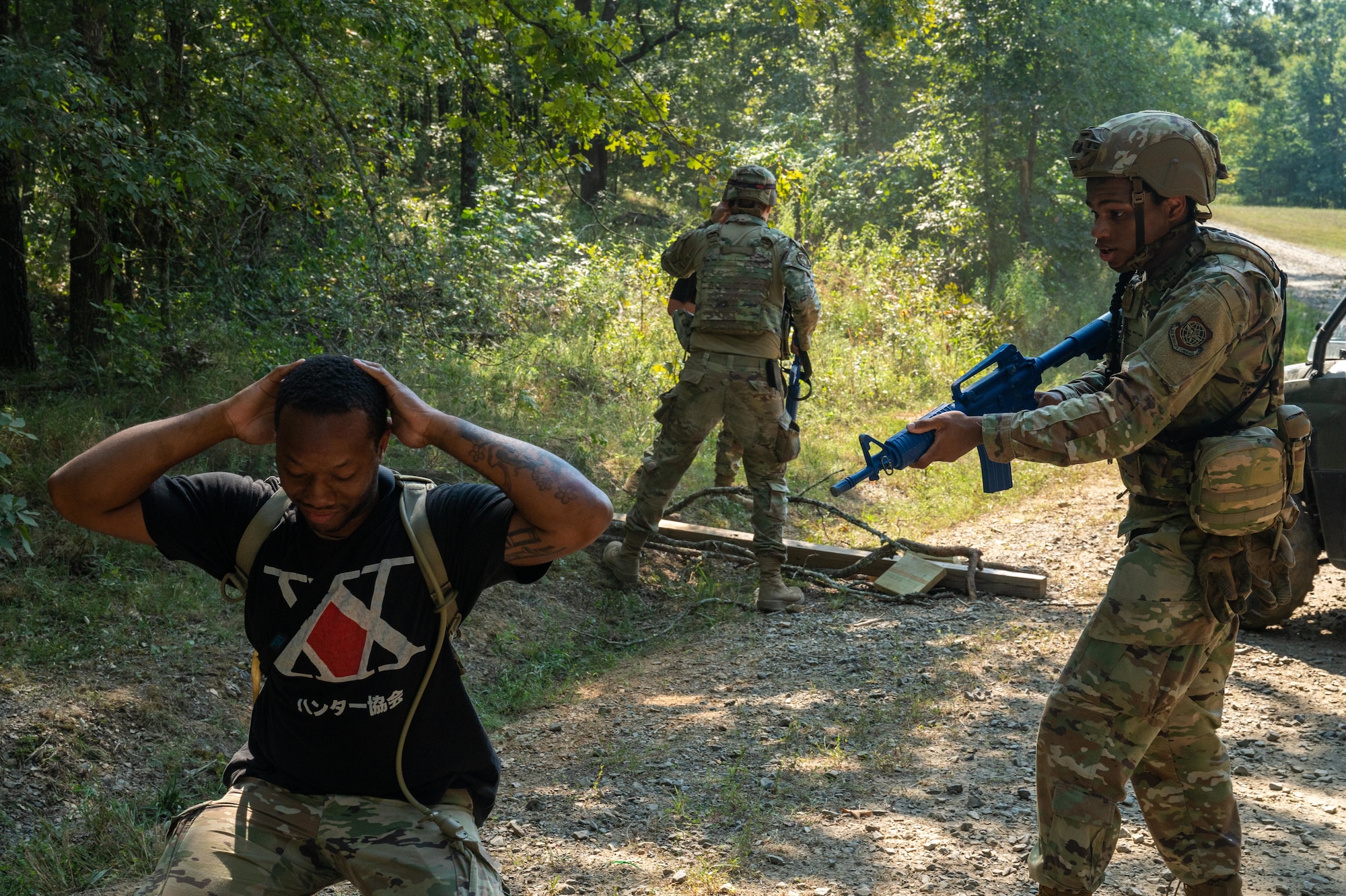 U.S. Air Force Senior Airman Brian Marshall, 21st Combat Air Base Squadron food service journeyman, detains a training member of the opposing force during exercise Bamboo Eagle 25-3 at Camp Robinson, Arkansas, Aug. 6, 2025. During BE 25-3, Airmen routinely responded to simulated intrusions to test their skills while under pressure. (U.S. Air Force photo by Airman 1st Class Adrien Tran)