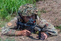 U.S. Air Force Staff Sgt. Ryan Racic, 23rd Base Defense Squadron fire team leader, defends an entry control point during exercise Bamboo Eagle 25-3 at Camp Robinson, Arkansas, August 3, 2025. Exercise BE 25-3 is designed to test readiness through intricate exercises, improve rapid deployment of forces, and exercise mission command. (U.S. Air Force photo by Senior Airman Alondra Cristobal Hernandez)