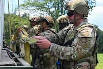 U.S. Air Force Airmen assigned to the 21st Combat Air Base Squadron unload cargo at a forward operating site during exercise Bamboo Eagle 25-3 at Camp Robinson, Arkansas, August 2, 2025. During BE 25-3, Airmen were provided opportunities to practice Agile Combat Employment by rapidly establishing forward operating sites, demonstrating how forces can be dispersed, mobilized and sustained across a broad operational theater. (U.S. Air Force photo by Airman 1st Class Adrien Tran)