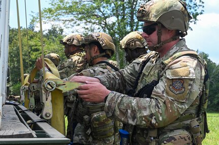 U.S. Air Force Airmen assigned to the 21st Combat Air Base Squadron unload cargo at a forward operating site during exercise Bamboo Eagle 25-3 at Camp Robinson, Arkansas, August 2, 2025. During BE 25-3, Airmen were provided opportunities to practice Agile Combat Employment by rapidly establishing forward operating sites, demonstrating how forces can be dispersed, mobilized and sustained across a broad operational theater. (U.S. Air Force photo by Airman 1st Class Adrien Tran)