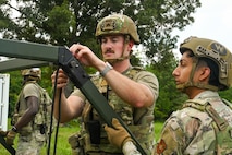 U.S. Air Force Airmen assigned to the 21st Combat Air Base Squadron assemble a tent at a forward operating site during exercise Bamboo Eagle 25-3 at Camp Robinson, Arkansas, August 2, 2025. Exercise BE 25-3 challenges the 21st Air Task Force to think critically and creatively to showcase their ability to adapt and innovate in the face of dynamic operational demands. (U.S. Air Force photo by Airman 1st Class Adrien Tran)