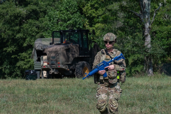 U.S. Air Force Tech. Sgt. Lamonica Lauritzen, 21st Combat Air Base Squadron material handling equipment section chief, maintains perimeter security at a forward operating site during exercise Bamboo Eagle 25-3 at Camp Robinson, Arkansas, August 3, 2025. Exercise BE 25-3 creates realistic, high-pressure environments that enhance readiness, strengthen teamwork, and build the skills. (U.S. Air Force photo by Senior Airman Alondra Cristobal Hernandez)