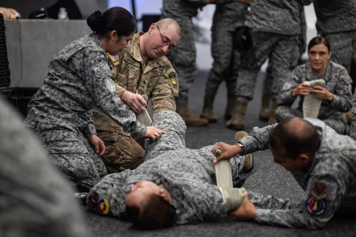 U.S. Army Staff Sgt. Hunter Vaught, combat medic program manager for the South Carolina Army National Guard, and Colombia Aerospace Force medical personnel practice a Level 2 Tactical Combat Casualty Care procedure during Relámpago de los Andes, a multinational exercise held at Palanquero Air Base, Colombia, Aug 2, 2025.