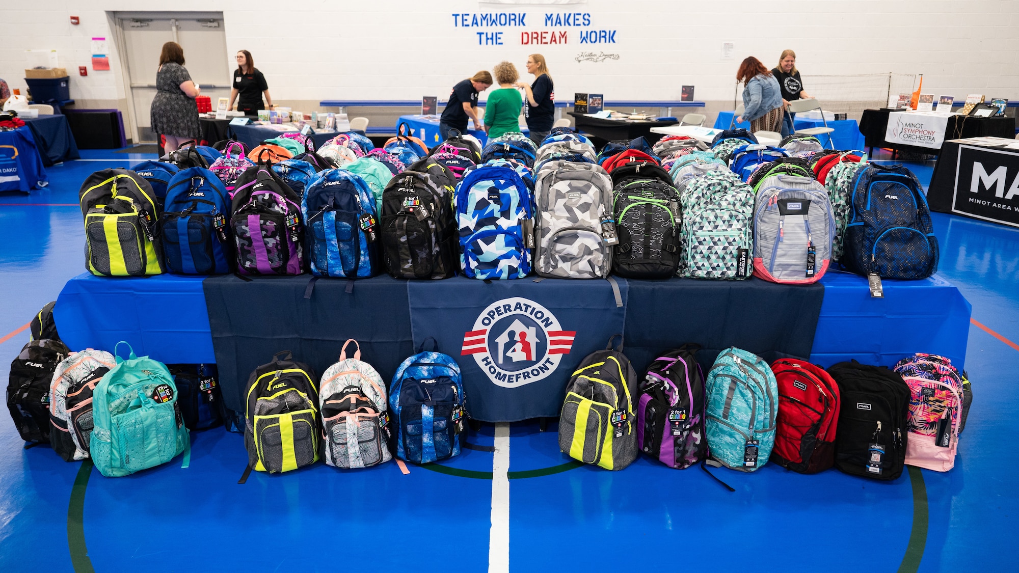 Backpacks sit on a table for the Back-to-School Supplies Brigade.