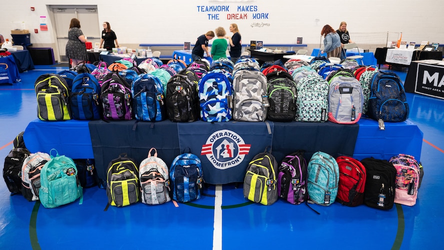 Backpacks sit on a table for the Back-to-School Supplies Brigade.