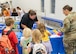 A military family interacts with Minot Air Force Base Environmental’s table during the Back-to-School Supplies Brigade.