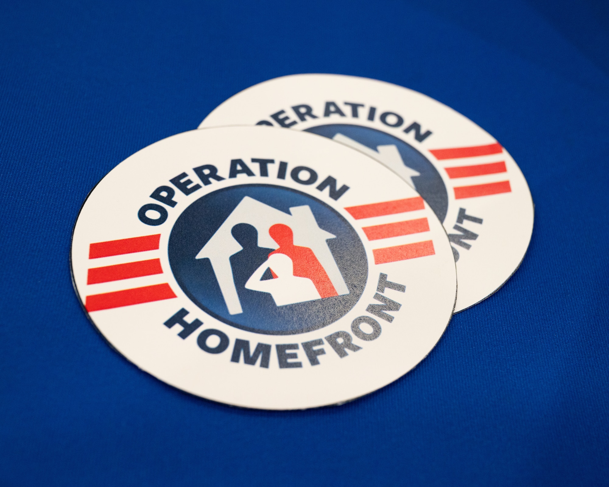 Two round cutouts saying "Operation Homefront" sit on a table.