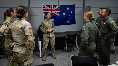 U.S. Air Force Airman 1st Class Hannah Abudayeh, center, 19th Operations Support Squadron all source intelligence analyst, briefs Allies and partners at Andersen AFB, Guam, during the Air Force’s 2025 Department-Level Exercise series, July 26, 2025. The DLE is a new way of conducting operations in a contested, dynamic environment to build capabilities making a stronger, deterrent force. The DLE series encompasses all branches of the Department of Defense, along with Allies and partners, employing more than 400 Joint and coalition aircraft and more than 12,000 members at more than 50 locations across 3,000 miles. (U.S. Air Force photo by Senior Airman Jade M. Caldwell)
