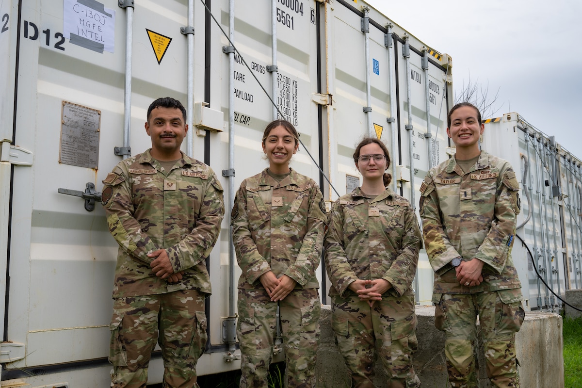 U.S. Airmen assigned to the 19th Operations Support Squadron and 317th OSS are photographed in front of a conex building at Andersen Air Force Base, Guam, during the Air Force’s 2025 Department-Level Exercise series, July 26, 2025. The DLE series is a new way of conducting operations in a contested, dynamic environment to build capabilities making a stronger, deterrent force. The DLE encompasses all branches of the Department of Defense, along with Allies and partners, employing more than 400 Joint and coalition aircraft and more than 12,000 members at more than 50 locations across 3,000 miles. (U.S. Air Force photo by Senior Airman Jade M. Caldwell)