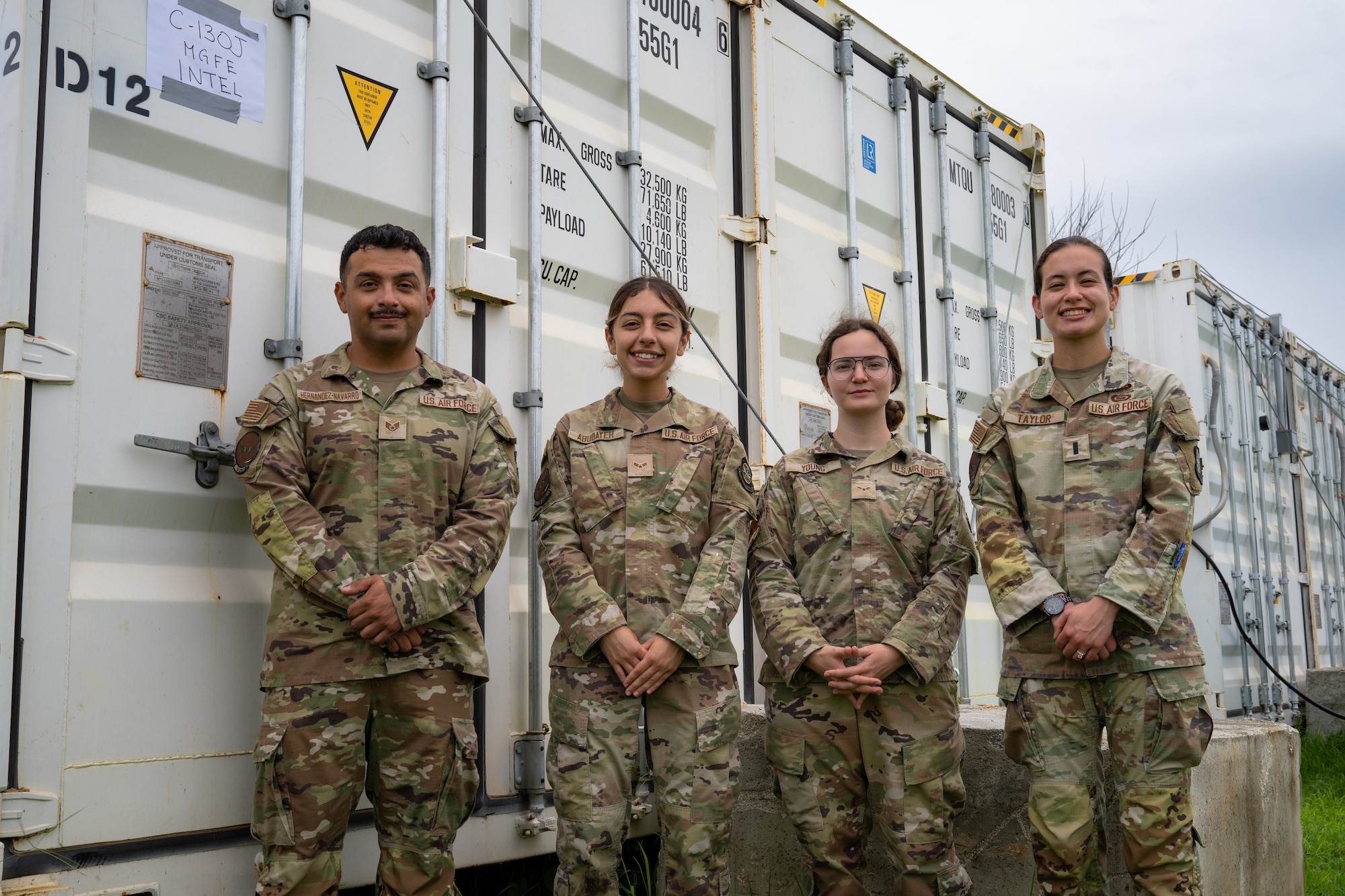 U.S. Airmen assigned to the 19th Operations Support Squadron and 317th OSS are photographed in front of a conex building at Andersen Air Force Base, Guam, during the Air Force’s 2025 Department-Level Exercise series, July 26, 2025. The DLE series is a new way of conducting operations in a contested, dynamic environment to build capabilities making a stronger, deterrent force. The DLE encompasses all branches of the Department of Defense, along with Allies and partners, employing more than 400 Joint and coalition aircraft and more than 12,000 members at more than 50 locations across 3,000 miles. (U.S. Air Force photo by Senior Airman Jade M. Caldwell)