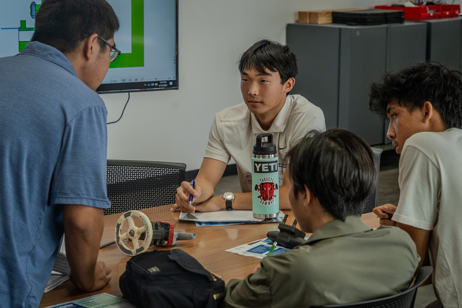 Junior Engineers Summer STEM Experience (JESSE) intern Rylan Terayama collaborates with fellow students during an engineering design challenge at Pearl Harbor Naval Shipyard’s and Maintenance Facility iLab, June 12, 2025.