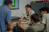 Junior Engineers Summer STEM Experience (JESSE) intern Rylan Terayama collaborates with fellow students during an engineering design challenge at Pearl Harbor Naval Shipyard’s and Maintenance Facility iLab, June 12, 2025.