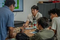 Junior Engineers Summer STEM Experience (JESSE) intern Rylan Terayama collaborates with fellow students during an engineering design challenge at Pearl Harbor Naval Shipyard’s and Maintenance Facility iLab, June 12, 2025.