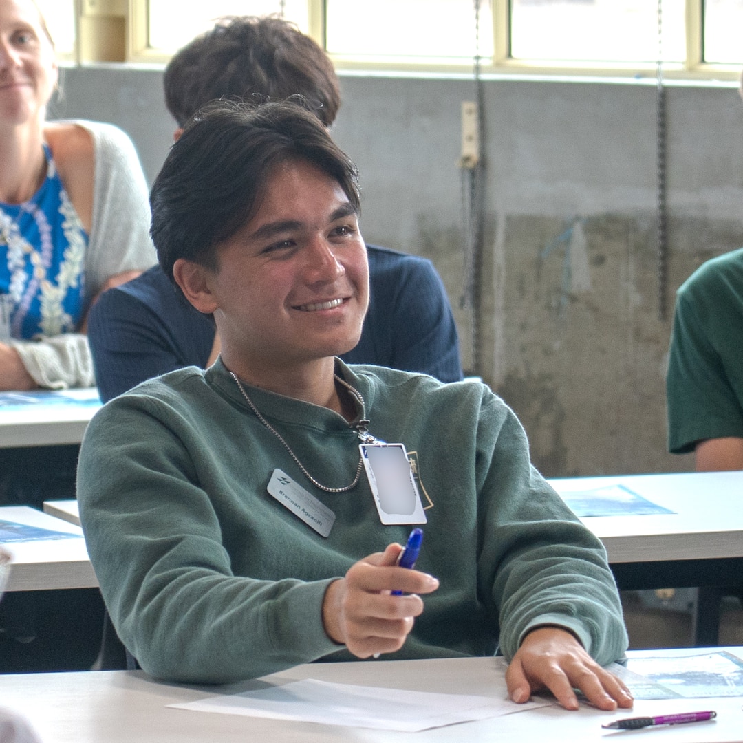 Junior Engineers Summer STEM Experience (JESSE) intern Brendan Kajioka listens during a welcoming briefing at Pearl Harbor Naval Shipyard and Maintenance Facility’s iLab, June 12, 2025.