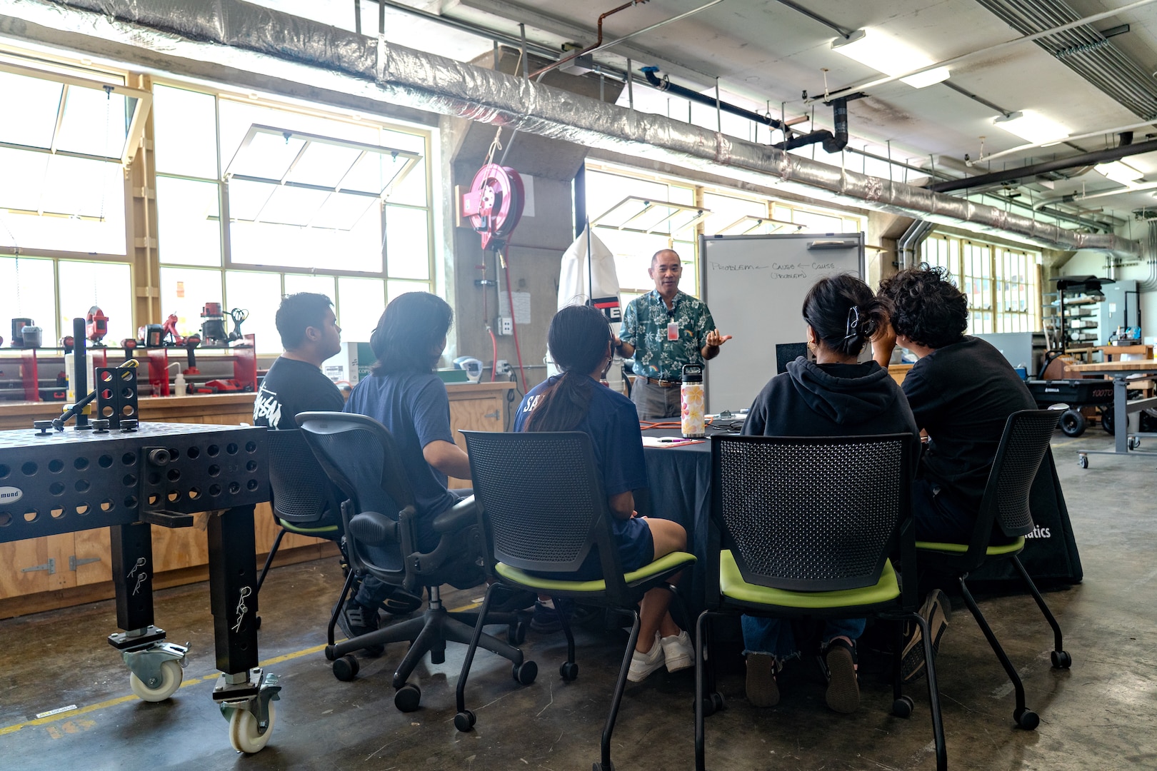 Sy Shimabukuro, an engineer at Pearl Harbor Naval Shipyard and Maintenance Facility explains troubleshooting principles to interns from the Junior Engineers Summer STEM Experience (JESSE) program during a hands-on workshop in the iLab, June 12, 2025.