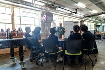 Sy Shimabukuro, an engineer at Pearl Harbor Naval Shipyard and Maintenance Facility explains troubleshooting principles to interns from the Junior Engineers Summer STEM Experience (JESSE) program during a hands-on workshop in the iLab, June 12, 2025.