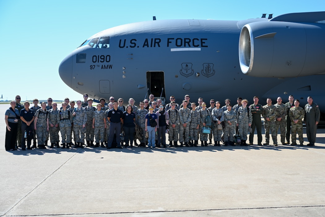 U.S. Air Force Airmen from the 58th Airlift Squadron (AS) take a group photo with Civil Air Patrol (CAP) cadets at Altus Air Force Base, Oklahoma, Aug. 6, 2025. CAP cadets were given an incentive flight by members from the 58th AS, featuring low-level maneuvers and a tour of a C-17 Globemaster III aircraft. (U.S. Air Force photo by Airman 1st Class Nathan Langston)