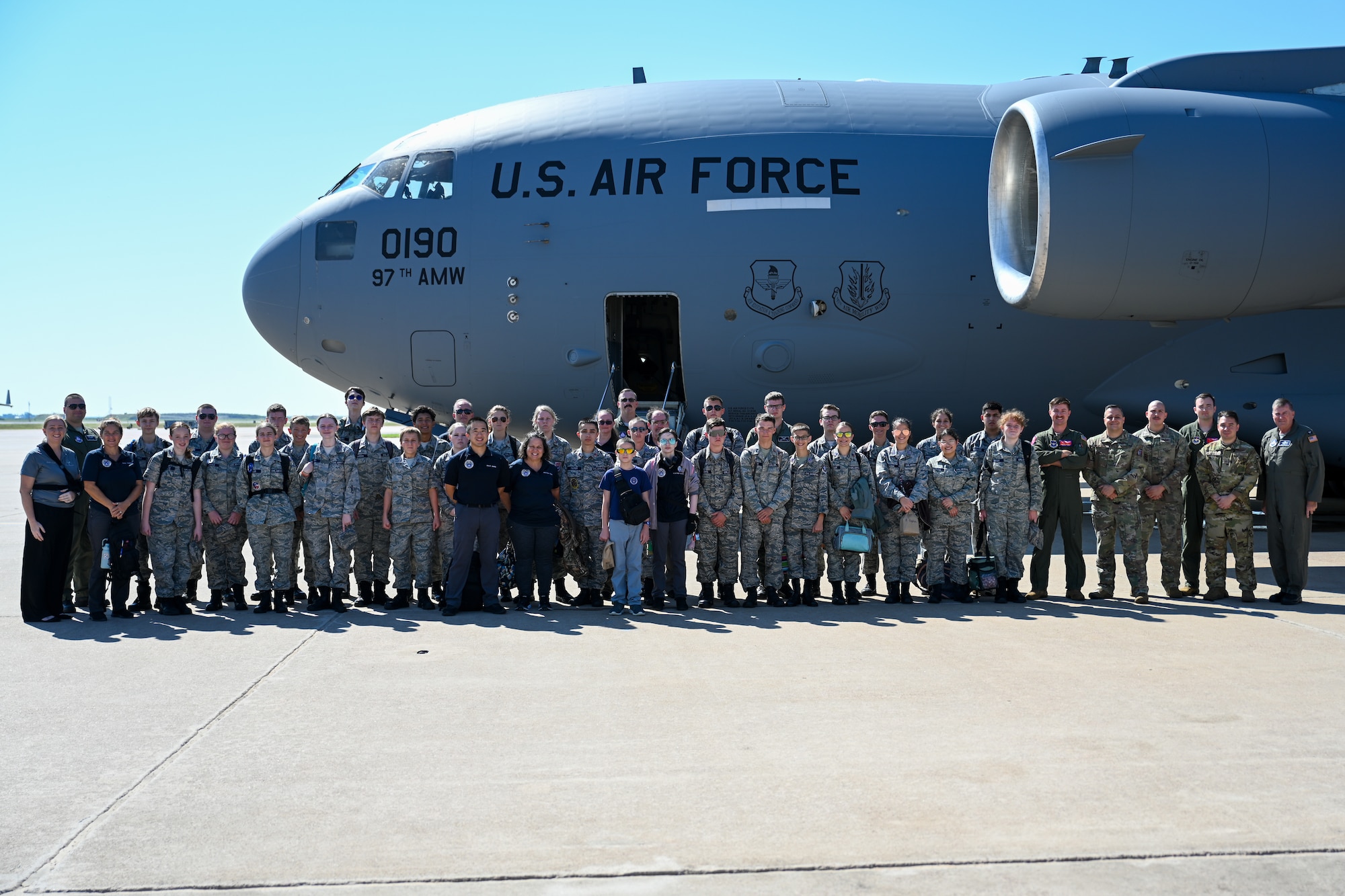 U.S. Air Force Airmen from the 58th Airlift Squadron (AS) take a group photo with Civil Air Patrol (CAP) cadets at Altus Air Force Base, Oklahoma, Aug. 6, 2025. CAP cadets were given an incentive flight by members from the 58th AS, featuring low-level maneuvers and a tour of a C-17 Globemaster III aircraft. (U.S. Air Force photo by Airman 1st Class Nathan Langston)