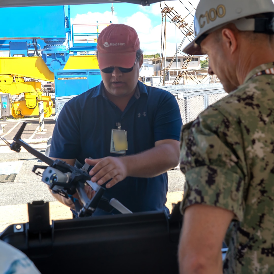 Pearl Harbor Naval Shipyard and Intermediate Maintenance Facility Commander Capt. Ryan D. McCrillis receives a briefing on drone capabilities from Naval Information Warfare Center technician June 18, 2025.