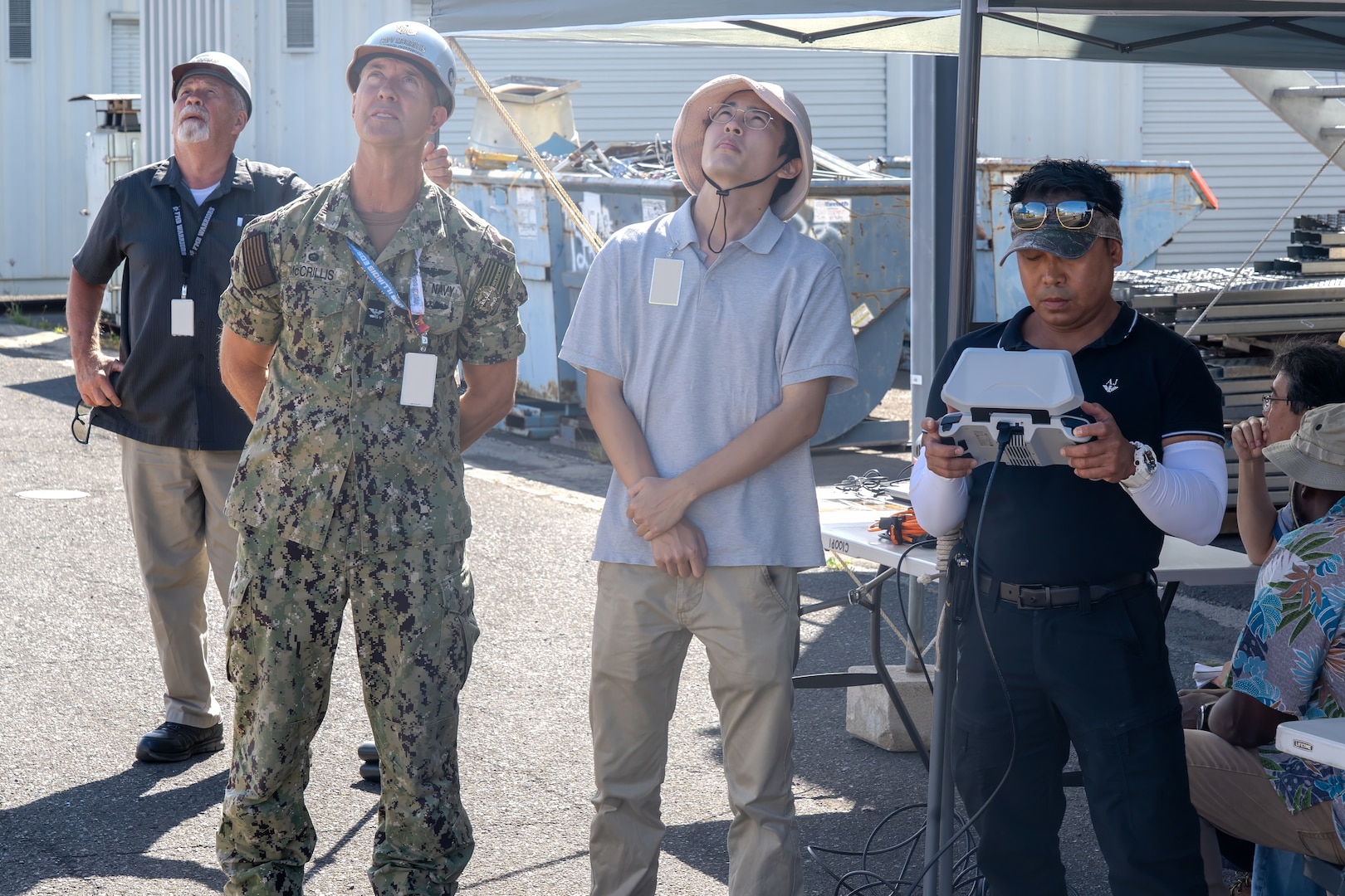 Pearl Harbor Naval Shipyard and Intermediate Maintenance Facility Commander Capt. Ryan D. McCrillis observes flight observations during a demonstration at Pearl Harbor Naval Shipyard & Intermediate Maintenance Facility, Hawaii, June 18, 2025.