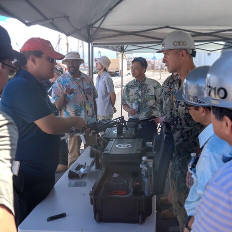 Pearl Harbor Naval Shipyard and Intermediate Maintenance Facility Commander Capt. Ryan D. McCrillis receives a briefing on drone capabilities from Naval Information Warfare Center technician June 18, 2025.