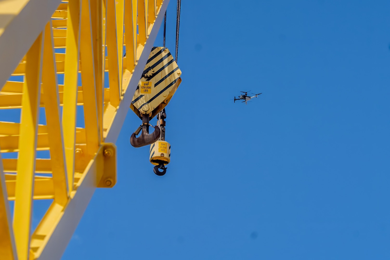 A Skydio X10D drone hovers near a crane during a demonstration at Pearl Harbor Naval Shipyard & Intermediate Maintenance Facility, Hawaii, June 18, 2025.