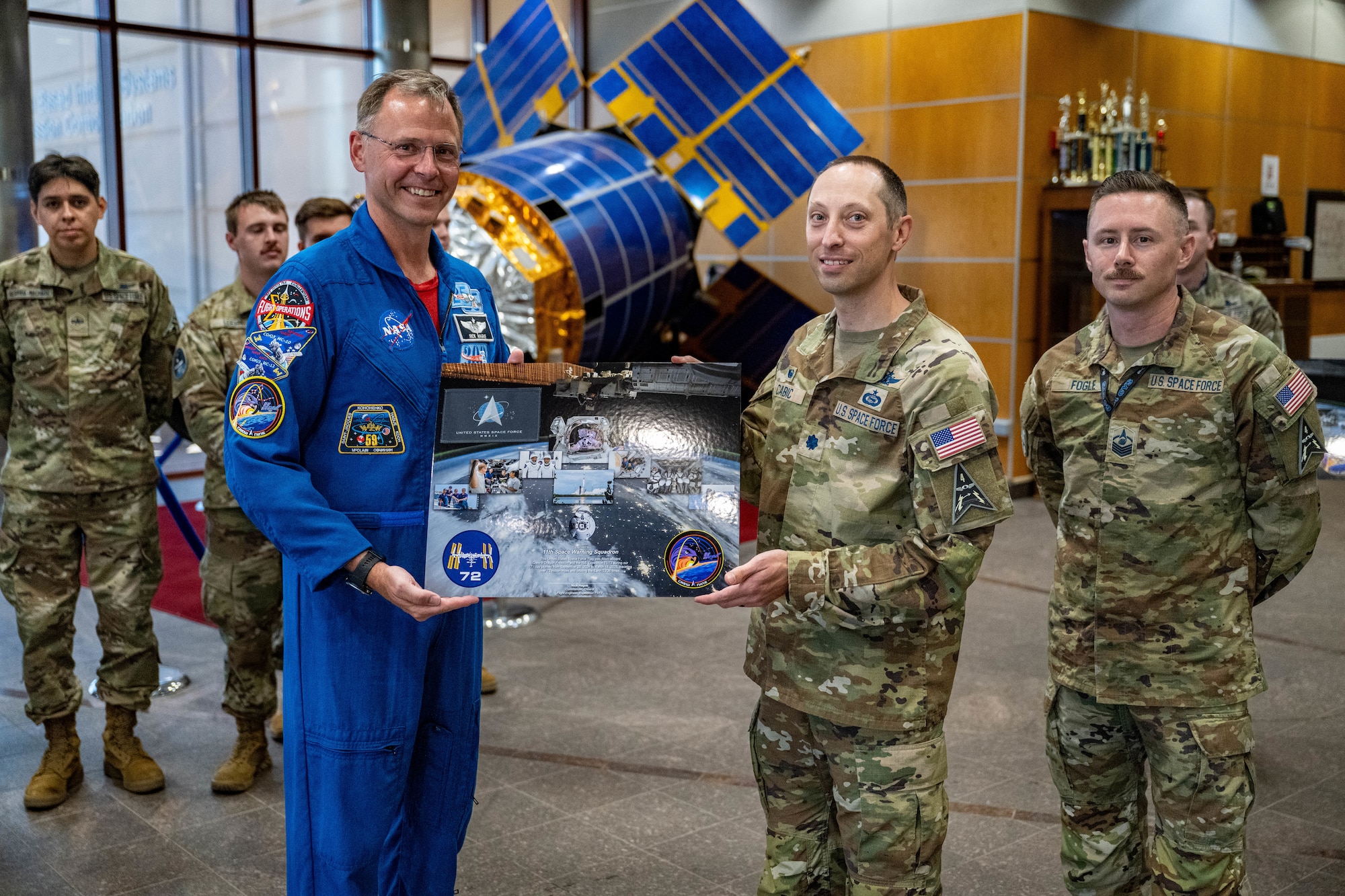 astronaut presents award to military member