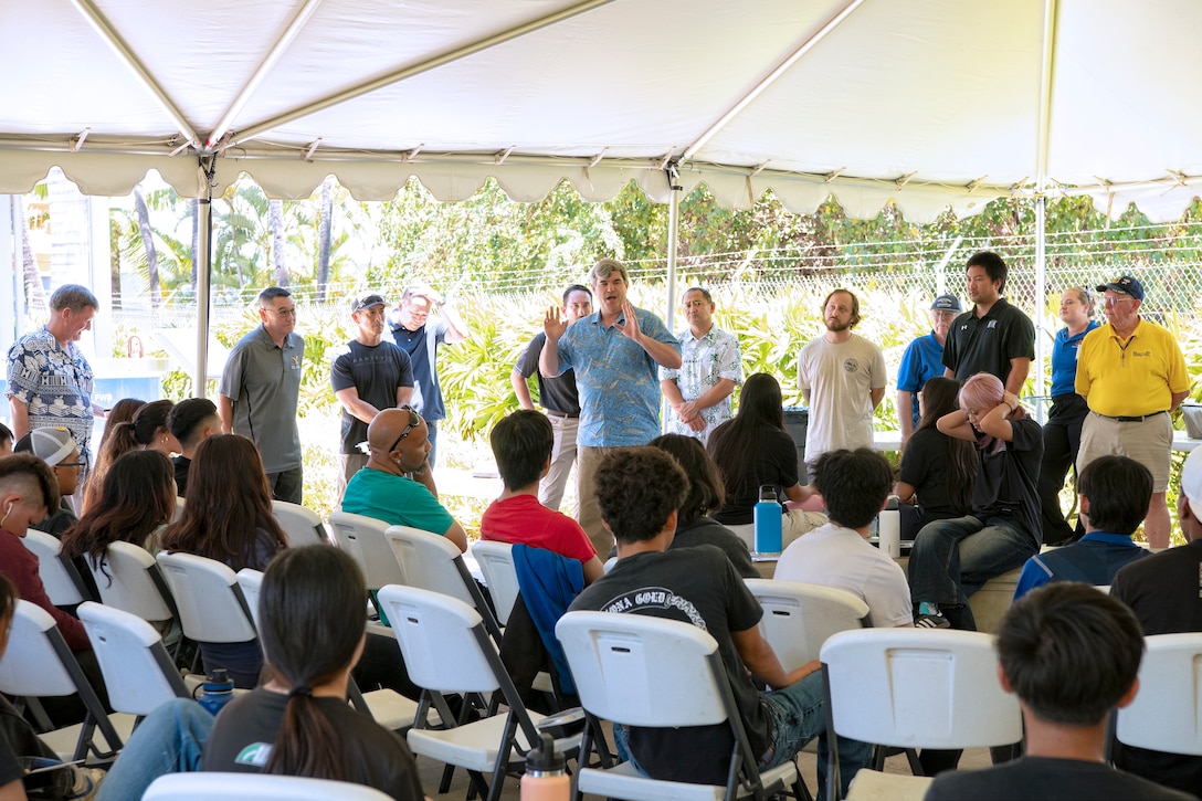 Andrew “Homer” Ring, Executive Director of the Pacific Fleet Submarine Museum, speaks with Honolulu Community College CTE students about the various trades career opportunities available locally at the Pacific Fleet Submarine Museum where volunteers from Pearl Harbor Naval Shipyard and Intermediate Maintenance Facility participated, July 15, 2025.