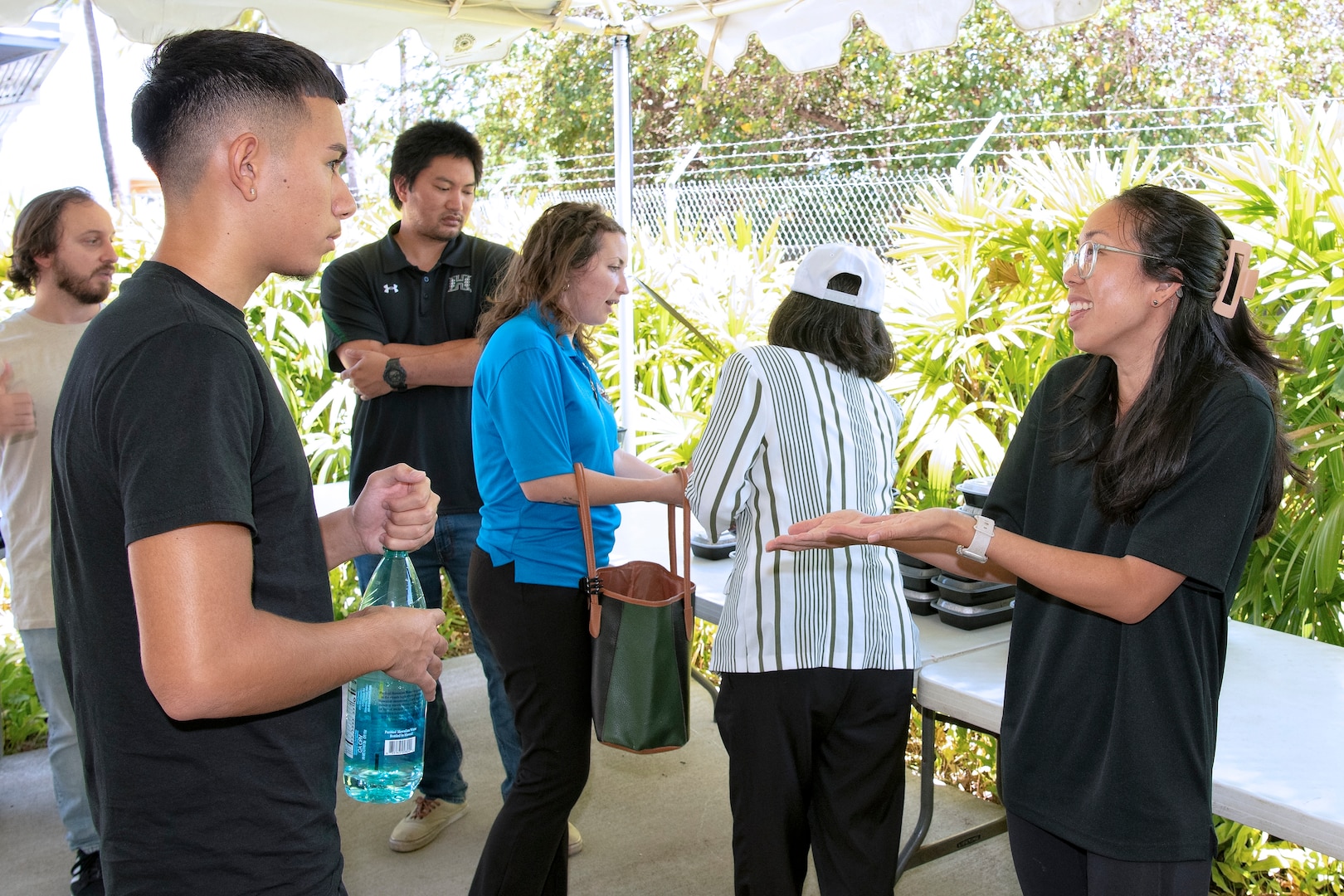Engineer Traci Sunada from Pearl Harbor Naval Shipyard and Intermediate Maintenance Facility talks with a student from the Honolulu Community College CTE Academy during a community event at the Pacific Fleet Submarine Museum July 15, 2025.