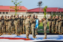 U.S. Army soldiers assigned to the 528th Military Intelligence Company, 2nd Infantry Division/ROK-U.S. Combined Division, uncase the unit guidon during the unit's activation ceremony August 5, 2025, on Camp Humphreys, South Korea.