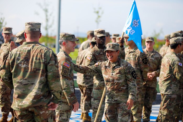 U.S. Army 1st Sgt. Christina Jiroudek assigned to the 528th Military Intelligence Company, 2nd Infantry Division/ROK-U.S. Combined Division, greets Lt. Col. Matthew Shoenfelt following the unit's activation ceremony August 5, 2025, on Camp Humphreys, South Korea.
