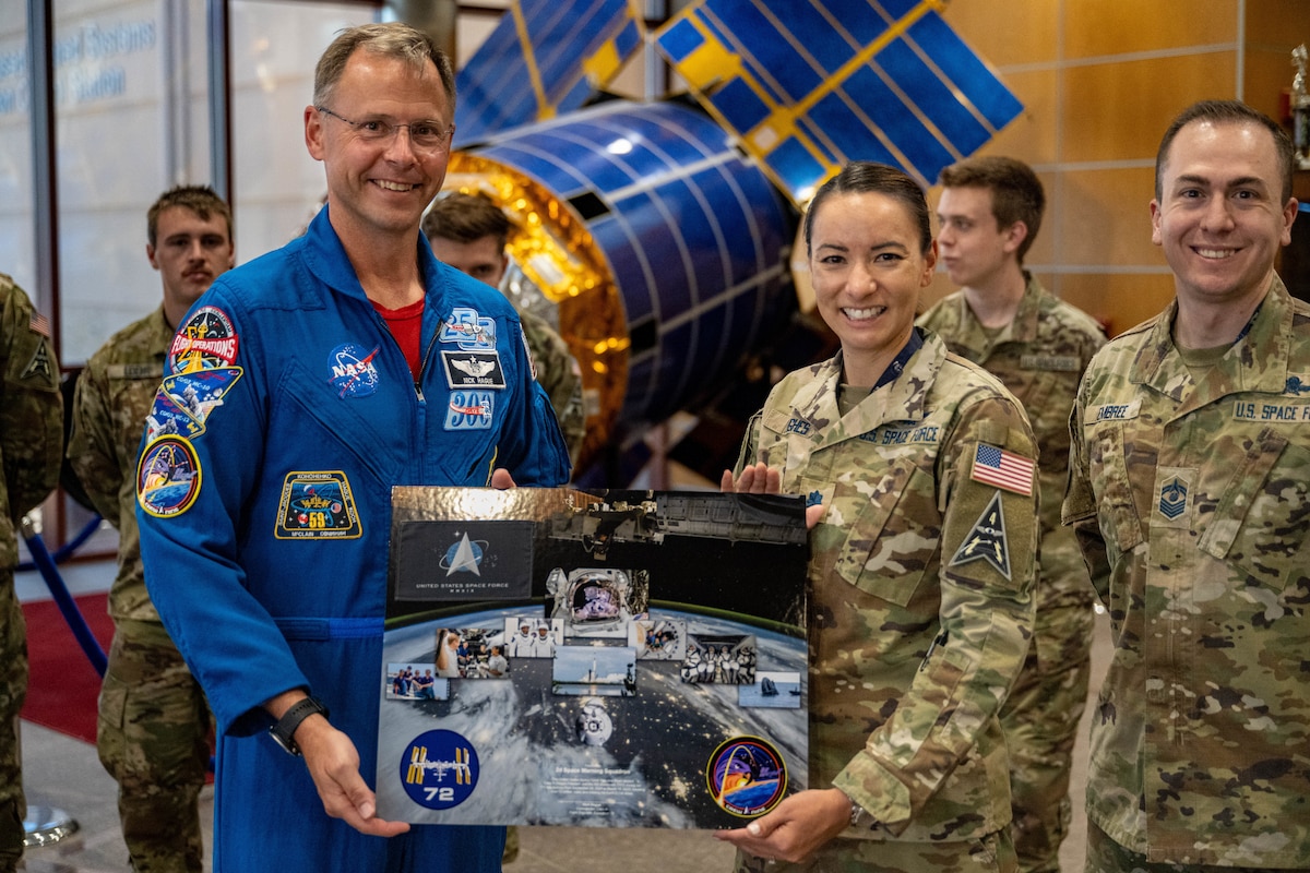 astronaut presents award to military member