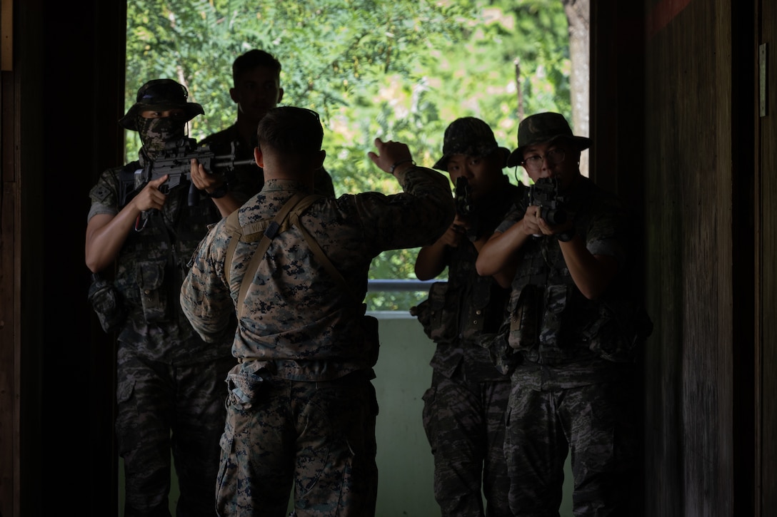 U.S. Marine Corps Cpl. Ian Walker, a rifleman with 2nd Battalion, 23rd Marines, forward deployed with 4th Marine Regiment, 3d Marine Division as part of the Unit Deployment Program, instructs Republic of Korea Marines on room clearing tactics during military operations in urban terrain training during the Korean Marine Exchange Program 25.2 in Pocheon, South Korea, July 22, 2025. KMEP is conducted regularly between the ROK and U.S. Marine Corps to increase their combined capabilities through realistic training geared towards deterring threats and maintaining peace in the Indo-Pacific. (U.S. Marine Corps photo by Lance Cpl. Van Hoang)
