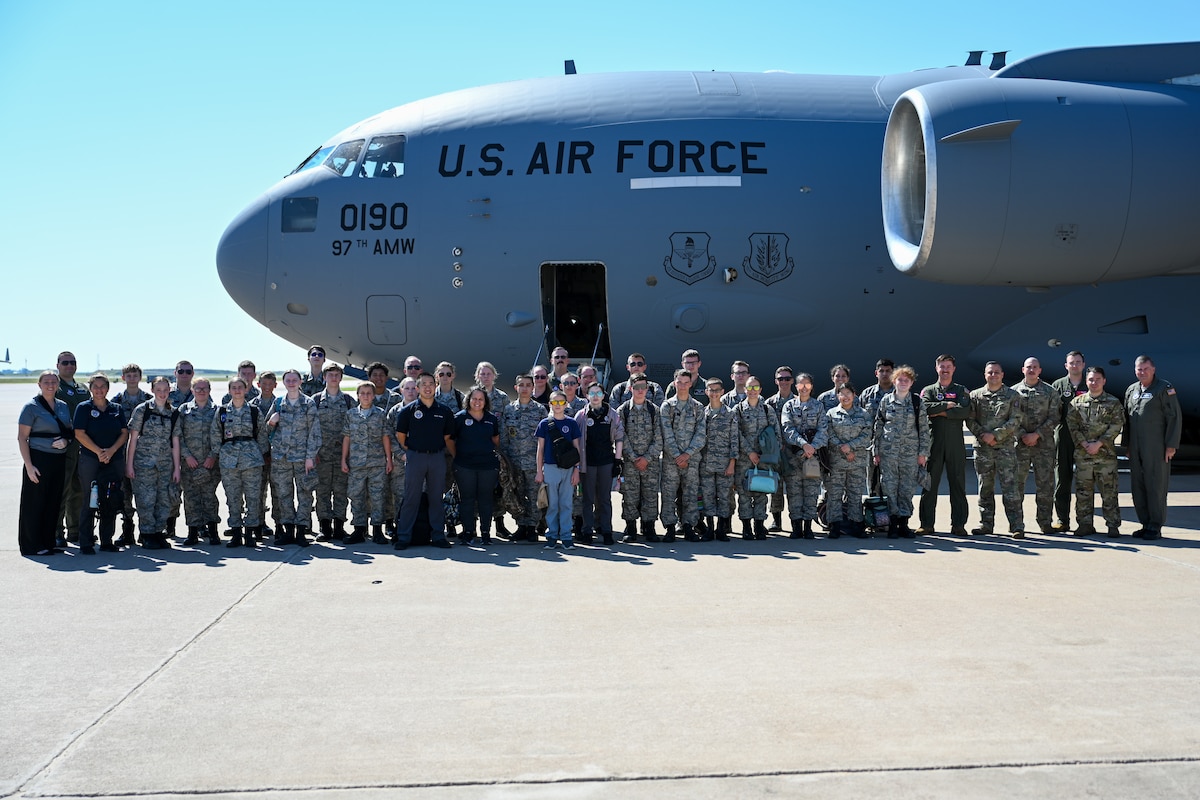 U.S. Air Force Airmen from the 58th Airlift Squadron (AS) take a group photo with Civil Air Patrol (CAP) cadets at Altus Air Force Base, Oklahoma, Aug. 6, 2025. CAP cadets were given an incentive flight by members from the 58th AS, featuring low-level maneuvers and a tour of a C-17 Globemaster III aircraft. (U.S. Air Force photo by Airman 1st Class Nathan Langston)
