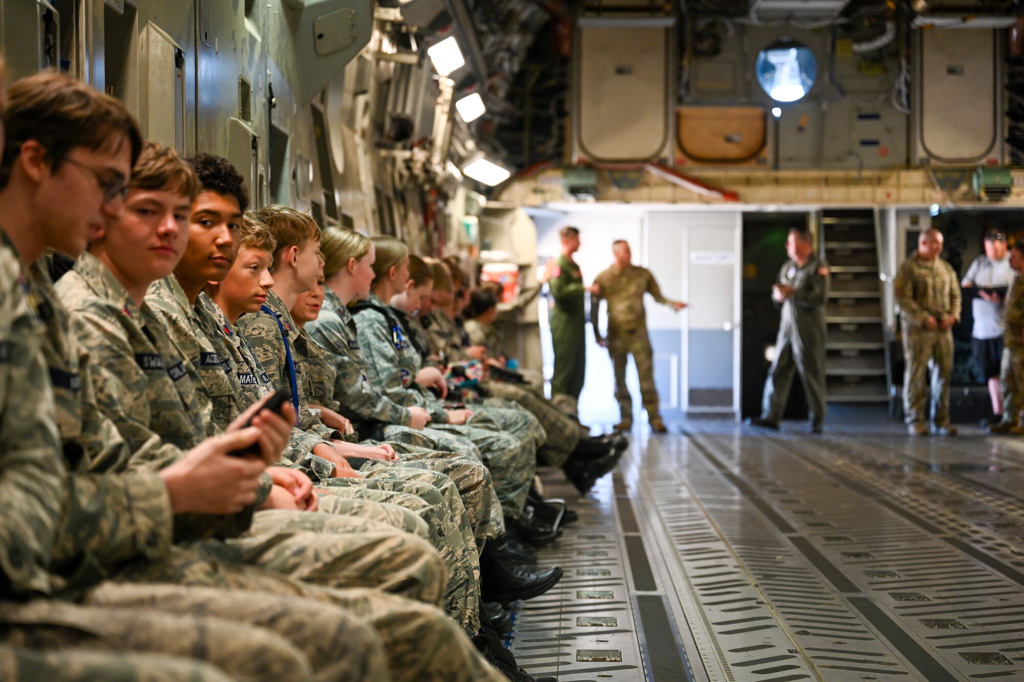 Civil Air Patrol (CAP) cadets wait for takeoff on a U.S. Air Force C-17 Globemaster III aircraft at Altus Air Force Base, Oklahoma, Aug. 6, 2025. While waiting to depart, CAP cadets were given an inside tour of the aircraft including the cockpit, ramp, and other utilities inside the main bay. (U.S. Air Force photo by Airman 1st Class Nathan Langston)